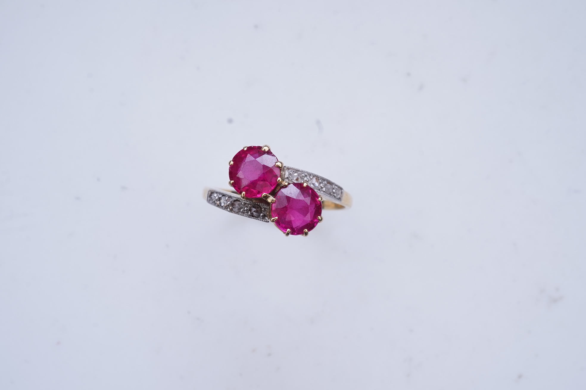 A synthetic ruby and diamond 'toi-et-moi' ring, early 20th century